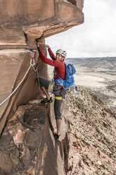 Ein Mann klettert an einem Turm aus Wüstensandstein, Naturita, Colorado. - AURF04050