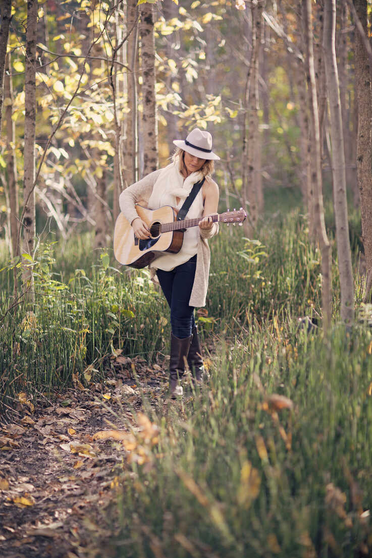 Teenage Girl Wearing Dress Holds Guitar On Shoulder In Studio Stock Photo -  Download Image Now - iStock