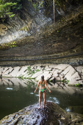 A young woman enjoys the Hamilton Pool near Wimberley, Texas on a hot day. - AURF04193