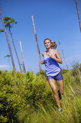 A young woman exercise on a Florida beach. - AURF04250