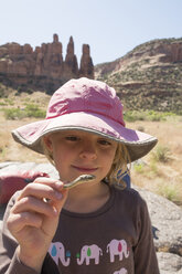 Ein Kind hält einen getrockneten Schlangenkopf am Colorado River, Fruita, Colorado. - AURF04360