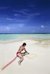 Young woman walking on sandbank beach, Maldives, Indian Ocean, Asia, Maafishi - AURF04410