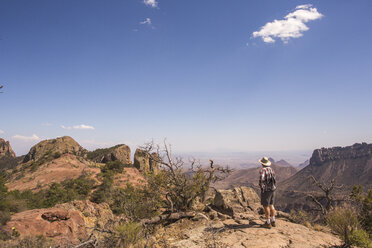 A Man Standing On A Rock Exploring Desert Landscape - AURF04491