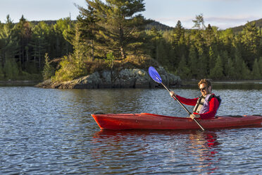 A Man Paddles His Kayak On Long Pond In Maine's North Woods Near Greenville, Maine - AURF04502