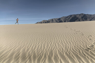 A person runs in the desert of death valley of California. - AURF04528