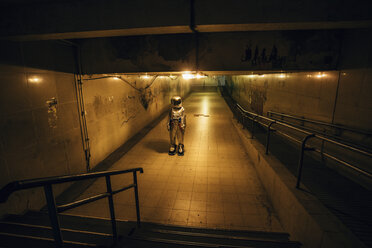 Spaceman in the city at night standing in underpass - VPIF00647