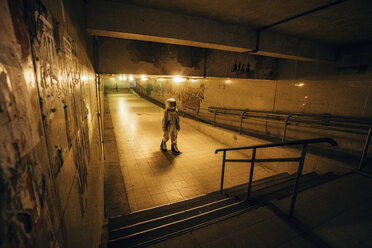 Spaceman in the city at night walking in underpass - VPIF00648