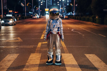 Spaceman standing on a street in the city at night - VPIF00709