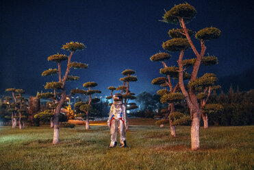 Spaceman standing in a park at night - VPIF00744