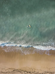 Indonesia, Bali, Aerial view of Pandawa beach, two surfers - KNTF01442