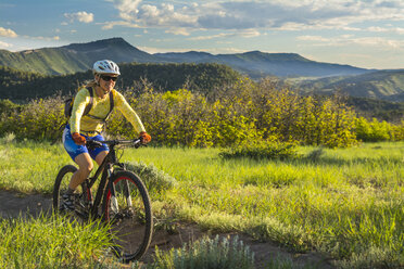 A woman mountain biking on the Horse Gulch Trail System, Durango, Colorado - AURF04619