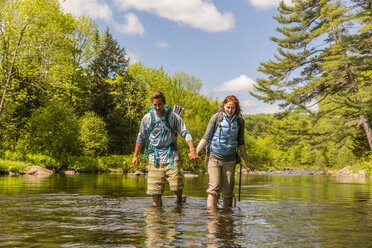 A Young Couple Ford The Pleasant River While Hiking On The Appalachian Trail - AURF04661