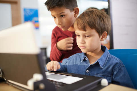 Konzentrierte Jungen mit Laptop, lizenzfreies Stockfoto