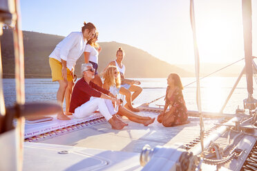 Friends relaxing on sunny catamaran - CAIF22131