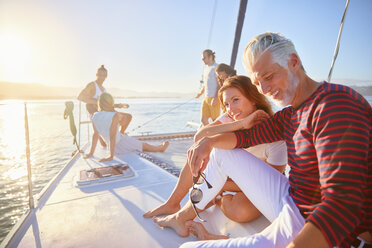 Friends relaxing on sunny catamaran - CAIF22141