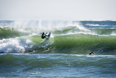 Men surfing large wave - AURF04711