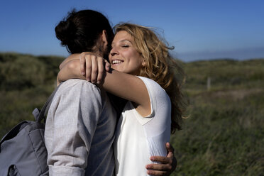 Happy young couple embracing affectionately - HHLMF00392
