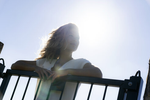 Portrait of a beautiful woman in summer, leaning on a gate - HHLMF00412