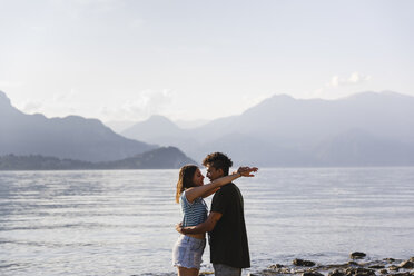 Happy affectionate young couple at the lakeside - MRAF00266