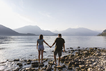 Young couple walking hand in hand at the lakeside - MRAF00271