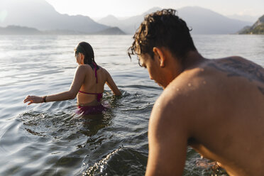 Young couple entering a lake - MRAF00280