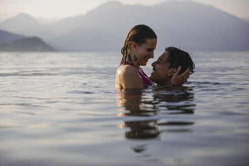Happy affectionate young couple in a lake - MRAF00282