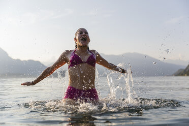 Happy young woman in a lake - MRAF00287