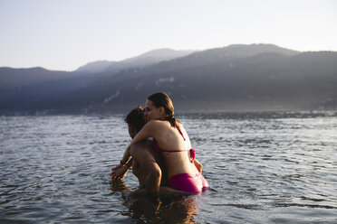 Happy affectionate young couple in a lake - MRAF00288