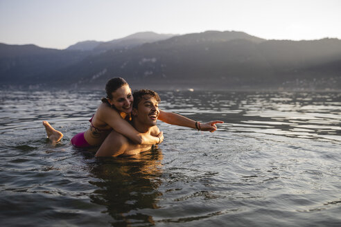 Happy carefree young couple in a lake - MRAF00299