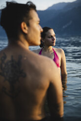 Young couple in a lake at sunset - MRAF00306