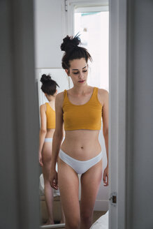 Young woman in underwear at home reflected in mirror - KKAF01826