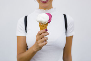 Woman's hand holding ice cream cone - MGIF00256