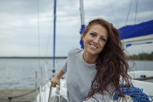 Porträt einer Frau, die sich auf einem Segelboot amüsiert - JZF00004