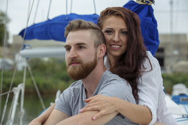 Portrait of a happy couple on a sailing boat - JZF00009