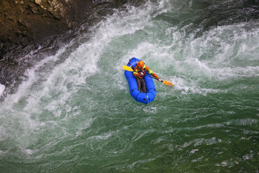 Evan Howard, an avid Explorer and adventurer, navigates a white water section of the Chehalis River on a packraft. - AURF05078