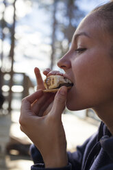 Nahaufnahme einer jungen Frau, die ein köstliches S'more isst - AURF05134