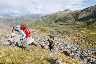 Man And Woman Hiking Up A Steep Hill In Talkeetna Range In Alaska, Usa - AURF05304