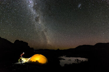 Man at his tent during starry night - AURF05307