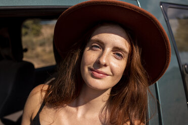 Portrait of smiling young woman wearing a hat in a car - AFVF01562