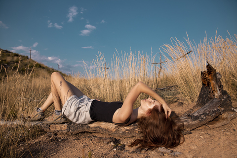 Young woman lying the rural landscape stock photo