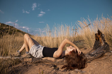 Young woman lying the rural landscape - AFVF01565