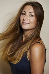 Portrait of freckled young woman with blowing hair - PNEF00869