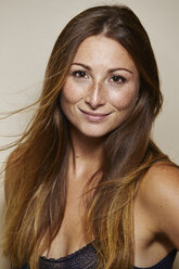 Portrait of freckled young woman with blowing hair - PNEF00870