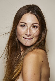 Portrait of freckled young woman with blowing hair - PNEF00878