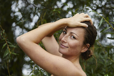 Porträt einer sommersprossigen jungen Frau in der Natur - PNEF00903