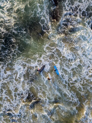 Indonesia, Bali, Aerial view of Dreamland beach, three surfers from above - KNTF01739