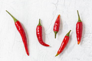 Five red chili pods on light ground - JUNF01252