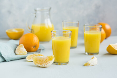 Glasses of freshly squeezed orange juice and orange slices - JUNF01262