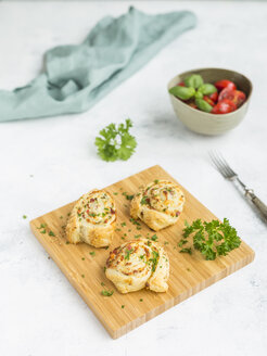 Sticky buns with feta, cream cheese, bacon and parsley on wooden board - JUNF01275