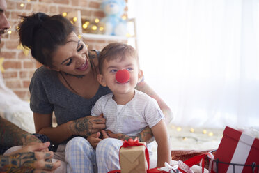 Glückliche Familie, die sich zu Weihnachten im Bett amüsiert - ABIF01045